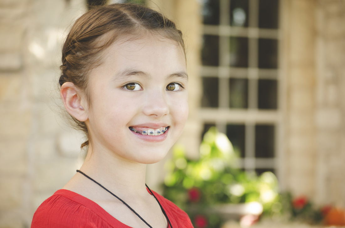 Image of smiling girl with braces | Celebrity Ortho Dentist