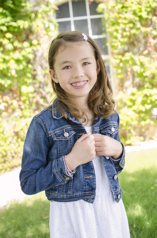 Image of smiling girl in denim jacket outdoors | Celebrity Ortho Dentist