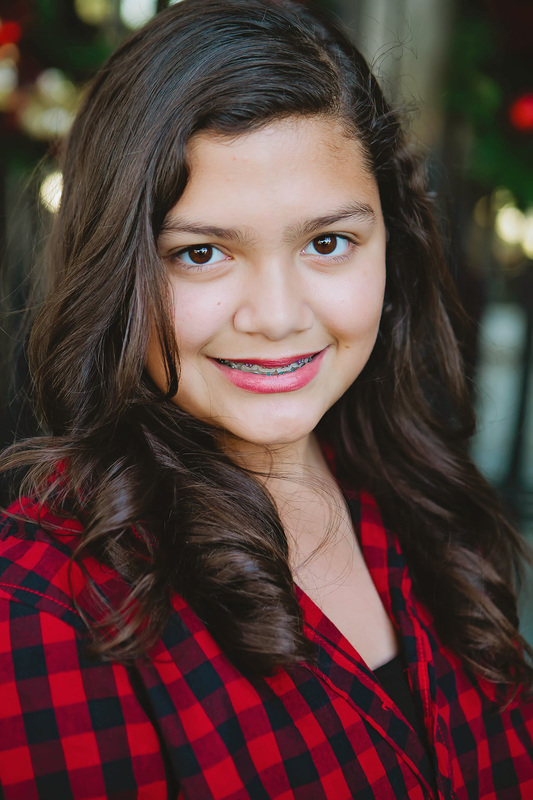 Image of girl in red plaid shirt smiling close-up | Celebrity Ortho Dentist
