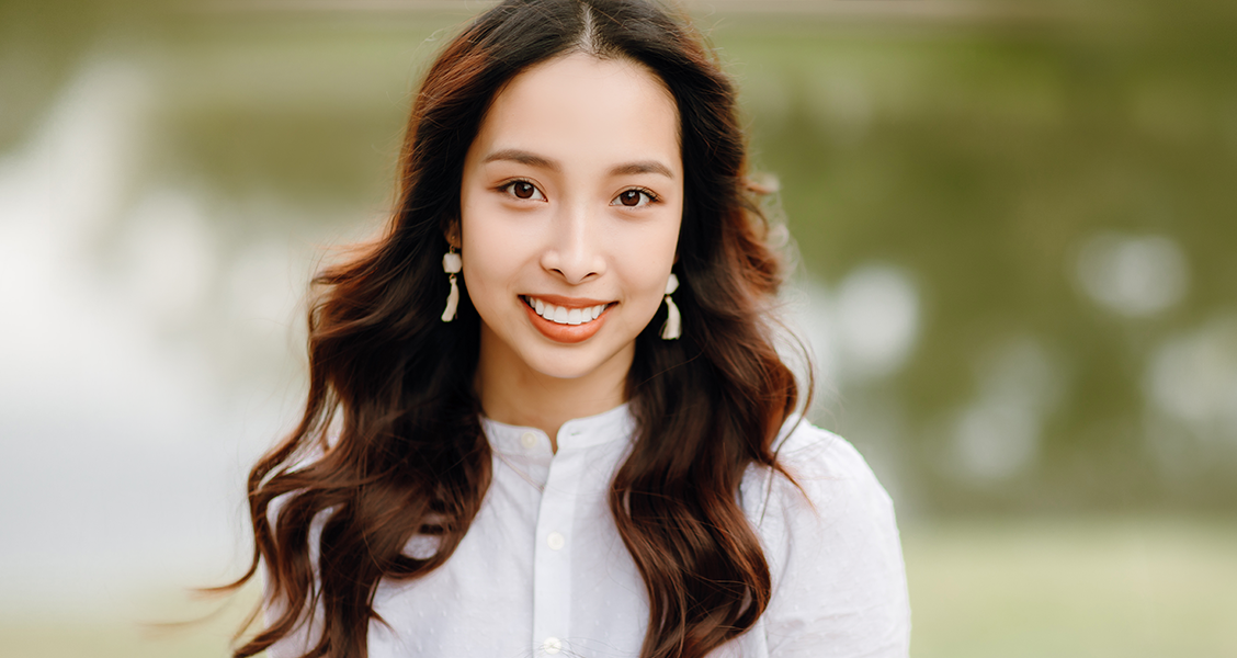 Image of woman in white top smiling at camera | Celebrity Ortho Dentist
