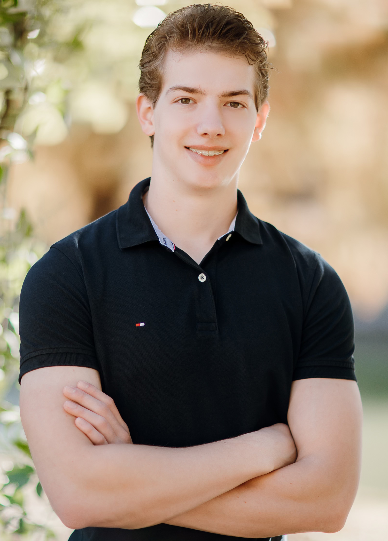 Blonde teen boy with clear braces smiling for photo | Celebrity Orthodontics