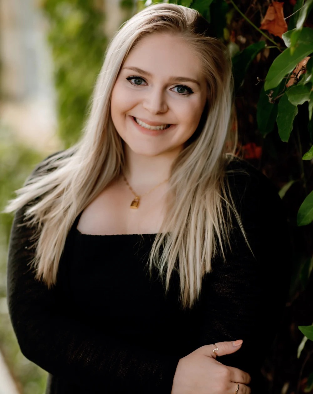 Smiling blonde woman posing for photo | Celebrity Orthodontics