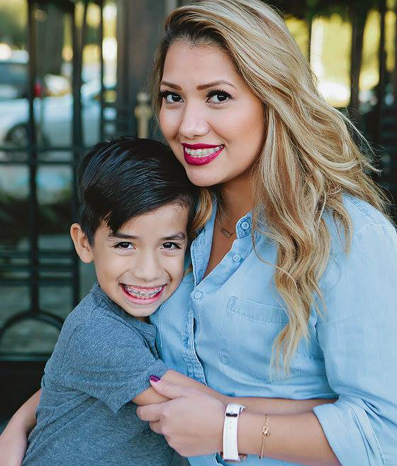 Smiling mom and son with braces posing for photo | Celebrity Orthodontics