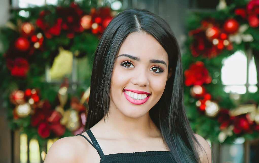 Portrait of young woman with dark hair smiling